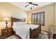 Bedroom with wood bed frame and window with shutters at 10432 E Winter Sun Dr, Scottsdale, AZ 85262