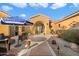 Inviting courtyard entry with seating and umbrella at 10432 E Winter Sun Dr, Scottsdale, AZ 85262