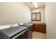 Laundry room with washer, dryer, and wood cabinets at 10432 E Winter Sun Dr, Scottsdale, AZ 85262