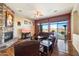 Relaxing living room with stone fireplace and access to backyard patio at 10432 E Winter Sun Dr, Scottsdale, AZ 85262