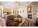 Spacious living area with hardwood floors and a cozy stone fireplace at 10432 E Winter Sun Dr, Scottsdale, AZ 85262