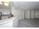 Modern kitchen with breakfast bar and stone backsplash at 13261 W Countryside Dr, Sun City West, AZ 85375