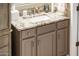 Bathroom vanity with granite countertop and brushed nickel hardware at 13321 W Chapala Ct, Sun City West, AZ 85375