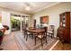 Bright dining room featuring hardwood floors and a wood table with chairs at 13321 W Chapala Ct, Sun City West, AZ 85375