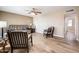 Living room with wood-look tile floors, a sofa, and two armchairs at 13502 W Hyacinth Dr, Sun City West, AZ 85375