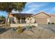 One-story home with desert landscaping, two-car garage, and a welcoming front porch at 14229 W Territorial Ln, Sun City West, AZ 85375