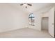 Bedroom with ceiling fan and arched window at 1437 W Iris Dr, Gilbert, AZ 85233