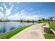 Peaceful lakeside walking path with benches at 1437 W Iris Dr, Gilbert, AZ 85233