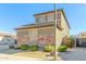 Two-story house with brown brick and a three-car garage at 17267 W Madison St, Goodyear, AZ 85338