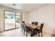 Dining area with wooden table, four chairs, and sliding glass doors to backyard at 17622 W Missouri Ave, Litchfield Park, AZ 85340