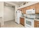 White appliances and wood cabinets in this kitchen at 18650 N 91St Ave # 4001, Peoria, AZ 85382