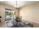 Dining area with a table, four chairs, and access to the backyard at 20283 N 273Rd Ave, Buckeye, AZ 85396