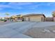 Spacious home with a large driveway and desert landscaping at 2491 E Milky Way, Gilbert, AZ 85295