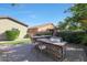 Alfresco dining with a stone-built outdoor kitchen at 27428 N Covered Wagon N Rd, Phoenix, AZ 85085