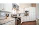 Modern kitchen featuring white cabinets and granite countertops at 319 W Vinedo Ln, Tempe, AZ 85284