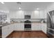 Modern kitchen with granite counters, white cabinets, and stainless steel appliances at 3751 E Fairmount Ave, Phoenix, AZ 85018