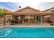 Home's backyard features a refreshing pool and covered patio at 4636 E Danbury Rd, Phoenix, AZ 85032