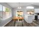 Kitchen dining area with wood table and wicker chairs, view of pool at 4636 E Danbury Rd, Phoenix, AZ 85032