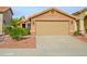 Tan colored garage with landscaping and walkway at 4636 E Danbury Rd, Phoenix, AZ 85032