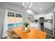 Bright kitchen with an island, dining area, and view of the backyard pool at 4636 E Danbury Rd, Phoenix, AZ 85032