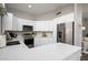 Modern kitchen with white cabinets, stainless steel appliances, and quartz countertops at 4636 E Danbury Rd, Phoenix, AZ 85032