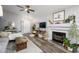 Cozy living room featuring a fireplace, hardwood floors, and ample natural light at 4636 E Danbury Rd, Phoenix, AZ 85032