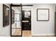 Spacious walk-in closet with built-in shelving and modern sliding barn door at 5700 E Sanna St, Paradise Valley, AZ 85253