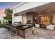 Luxury outdoor kitchen with built-in grill and bar seating at 5700 E Sanna St, Paradise Valley, AZ 85253