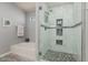 Elegant bathroom with a soaking tub, walk-in shower, and tiled floors at 5736 E Lawndale St, Mesa, AZ 85215