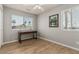 Bright bedroom with wood-look floors, window seating, and a ceiling fan at 5736 E Lawndale St, Mesa, AZ 85215