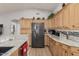 Modern kitchen with granite countertops, wood cabinets, and stainless steel appliances at 5736 E Lawndale St, Mesa, AZ 85215