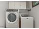 Laundry room with washer, dryer, and overhead cabinets at 5736 E Lawndale St, Mesa, AZ 85215