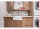 Laundry room with farmhouse sink and cabinets at 7131 E Foothill Dr, Paradise Valley, AZ 85253