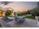 Outdoor dining area with seating for six, adjacent to a built-in grill and pool at 7131 E Foothill Dr, Paradise Valley, AZ 85253