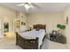 Spacious bedroom with a dark wood bed frame and ceiling fan at 8428 W Utopia Rd, Peoria, AZ 85382