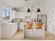 Modern white kitchen with stainless steel appliances and island at 8517 W Campbell Ave, Phoenix, AZ 85037