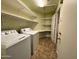 Laundry area with washer, dryer, and ample shelving at 881 E Appaloosa Rd, Gilbert, AZ 85296