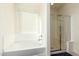 Bathroom featuring a bathtub and a separate shower stall at 9567 W Robin Ln, Peoria, AZ 85383