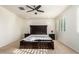 Light and airy bedroom with dark wood furniture and ceiling fan at 9567 W Robin Ln, Peoria, AZ 85383