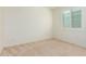 Bright bedroom with neutral walls and carpet, featuring a window with shutters at 9567 W Robin Ln, Peoria, AZ 85383