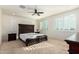 Spacious bedroom with dark wood furniture and plantation shutters at 9567 W Robin Ln, Peoria, AZ 85383