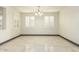 Dining room with white walls, gray baseboards, and white tile floor at 9567 W Robin Ln, Peoria, AZ 85383