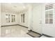 Entryway with white door, gray baseboards and white tile floor at 9567 W Robin Ln, Peoria, AZ 85383