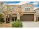 Two-story house with a large brown garage door and landscaping at 9567 W Robin Ln, Peoria, AZ 85383