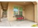 Small front porch with a wicker bench and red cushions at 9567 W Robin Ln, Peoria, AZ 85383
