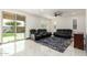 Gathering room with sliding door to backyard, tile floors and reclining furniture at 9567 W Robin Ln, Peoria, AZ 85383