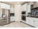Modern kitchen with stainless steel appliances and white cabinets at 9567 W Robin Ln, Peoria, AZ 85383