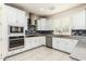 Modern kitchen with white cabinets, granite counters and stainless steel appliances at 9567 W Robin Ln, Peoria, AZ 85383