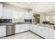 Modern kitchen with white cabinets, granite counters and stainless steel appliances at 9567 W Robin Ln, Peoria, AZ 85383