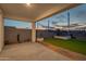 Covered patio with artificial turf and a small sitting area at 10541 W Sonrisas St, Tolleson, AZ 85353